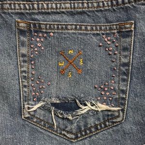 Hand-embroidered, distressed jean cut-off shorts